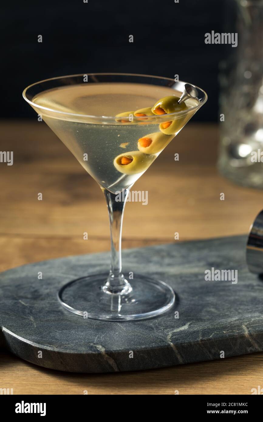 Boozy Traditional Dirty Martini with Olive Garnish Stock Photo