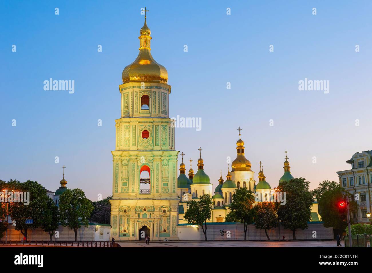 Saint Sophia's Cathedral with bell tower view at twilight, blooming chestnut trees and afterglow sky in background, Kyiv, Ukraine Stock Photo
