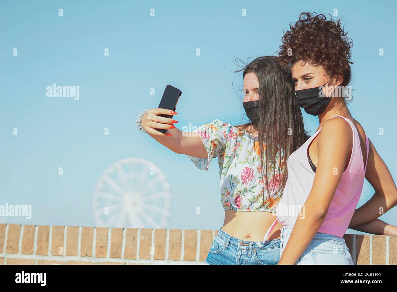 Happy young girls taking selfies Face mask concept Stock Photo Alamy