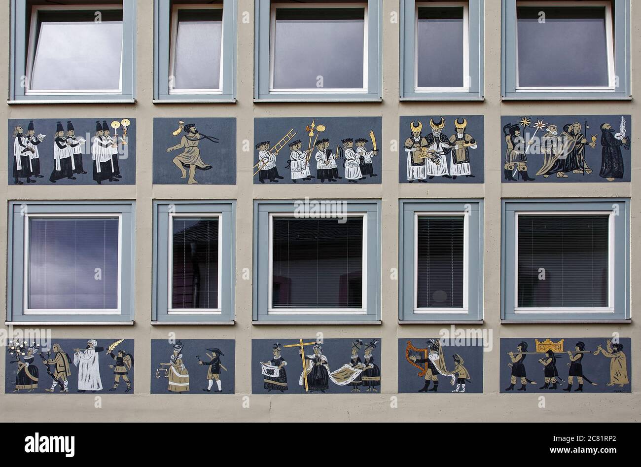 pictures painted on building exterior, between rows of windows ...