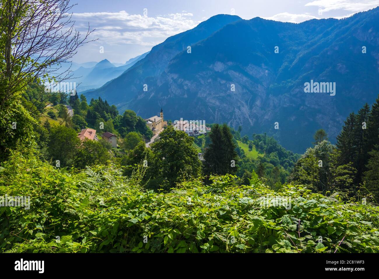 Pergine Valsugana, Italy - August 12, 2019: Village under mountain range and small town in valle of Italian Alps, Trentino Alto Adige, Trento Province Stock Photo