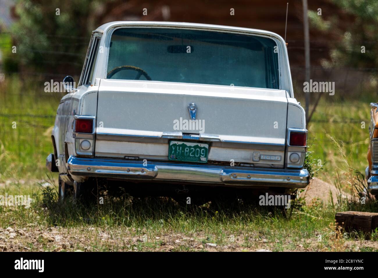 Old Jeep Wagoneer sitting in the weeds on a Colorado ranch Stock Photo