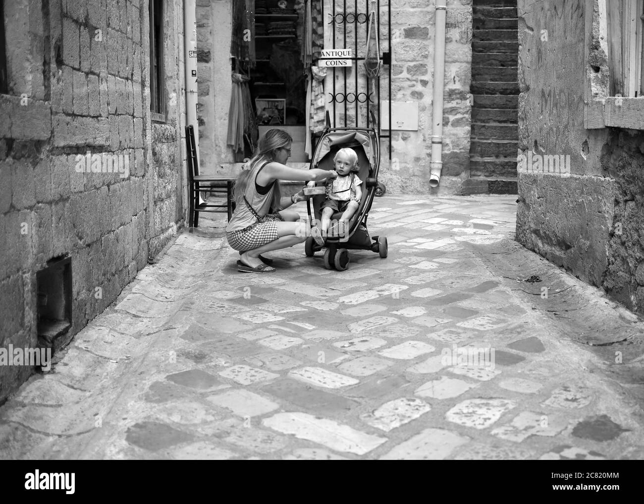 Kotor, Montenegro, Sep, 22, 2019: Woman with baby boy at the cobblestone street of Kotor Old Town Stock Photo