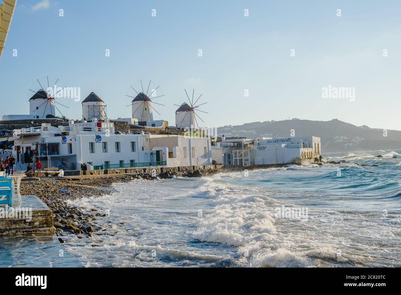 A number of mills on the hill near the sea on the island of Mykonos in Greece - the main attraction of the island Stock Photo
