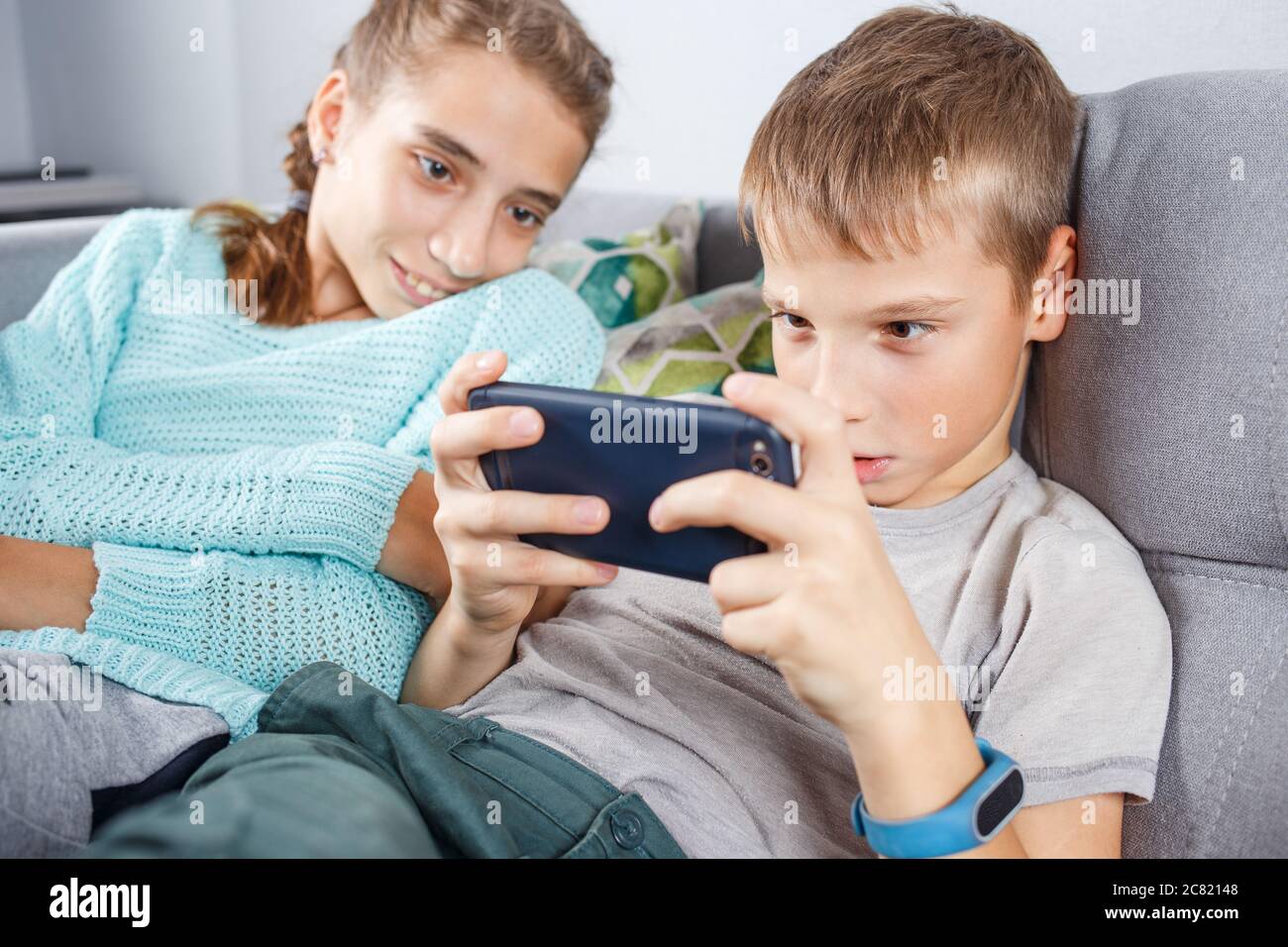 Boy with his sister spending time online at home Stock Photo