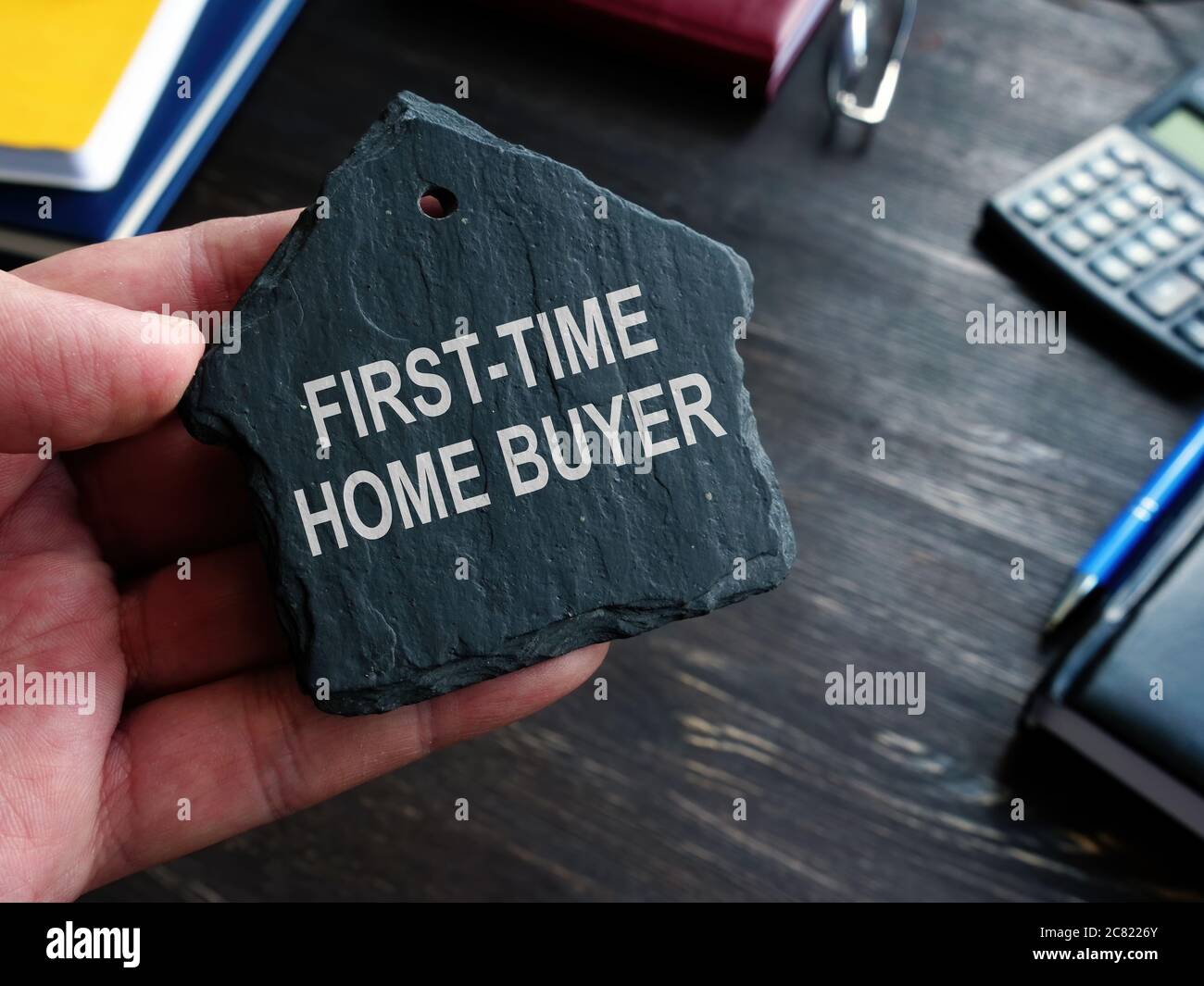 First time home buyer words on the stone house symbol. Stock Photo