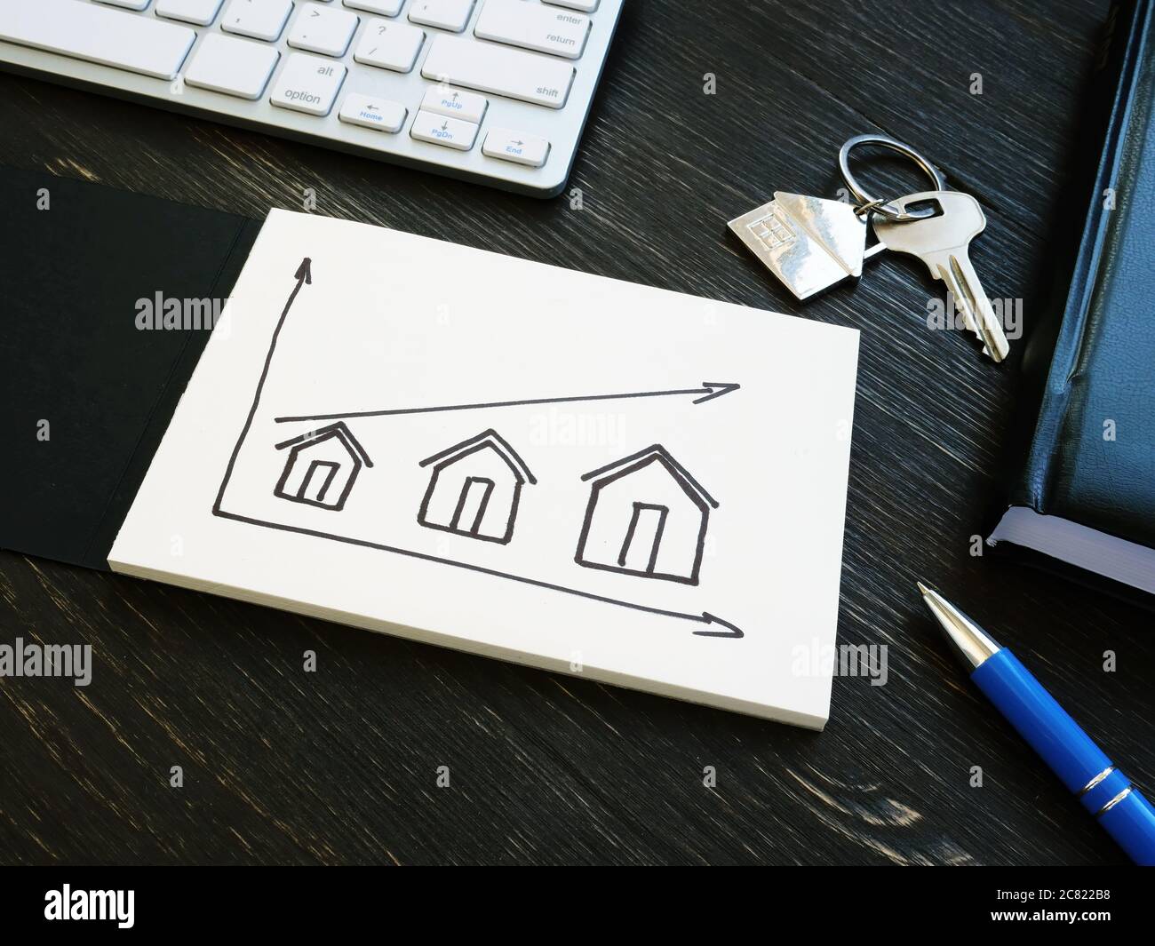 Investments in real estate. Graph with houses and an arrow Stock Photo