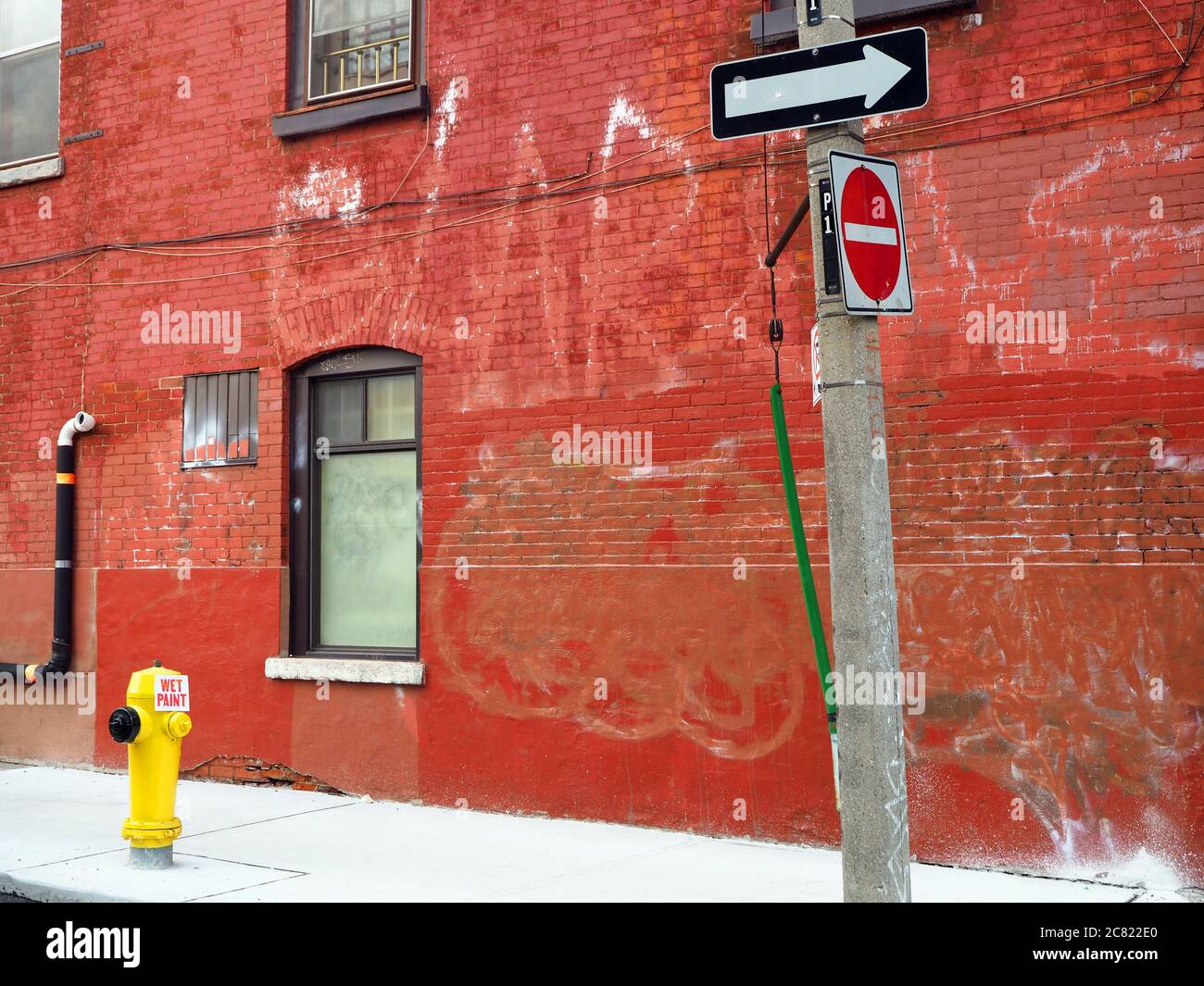 Red brick building with yellow fire hydrant, Toronto, Ontario, Canada Stock Photo