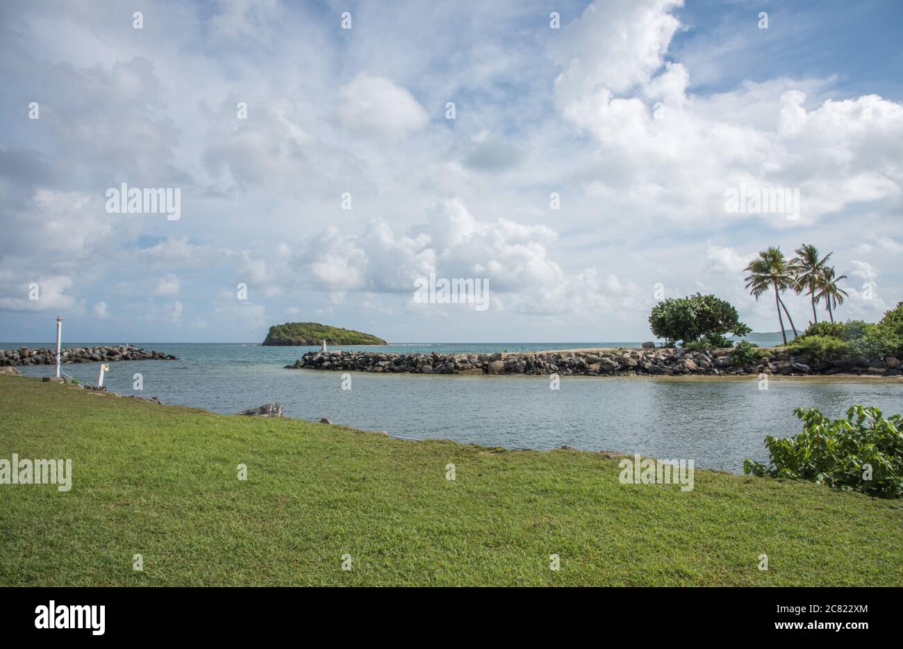 Groyne at Green Cay Marina entrance with island view in the Caribbean Sea on St. Croix in the USVI Stock Photo