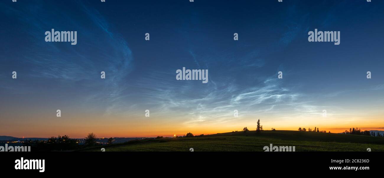 Noctilucent clouds. Night glowing silvery clouds.  wide panorama. Stock Photo
