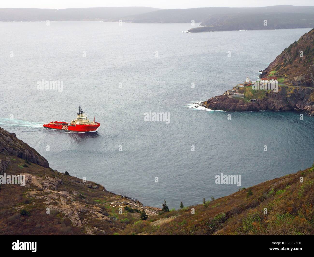 Atlantic Hawk offshore tug supply ship sailing through The Narrows into St John’s Harbour, Newfoundland, Canada Stock Photo