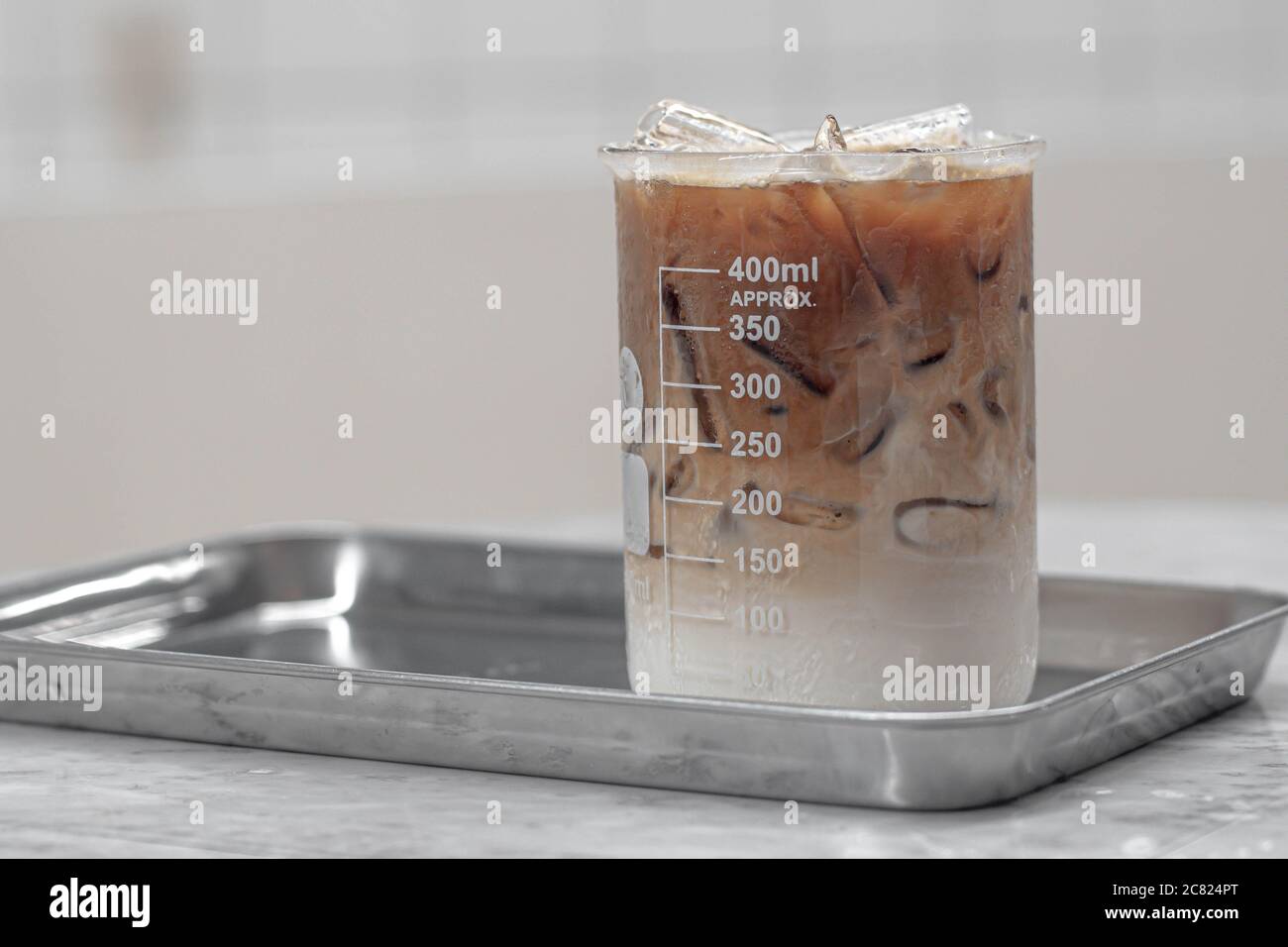 Beverage drinks come in a beaker. Cocktail served in a laboratory