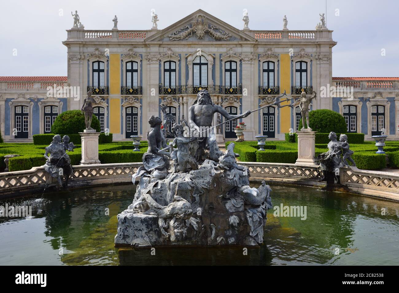 Neptune gardens, fountain (baroque) and the facades of the Queluz Royal Palace. Formerly used as the Summer residence by the Portuguese royal family Stock Photo