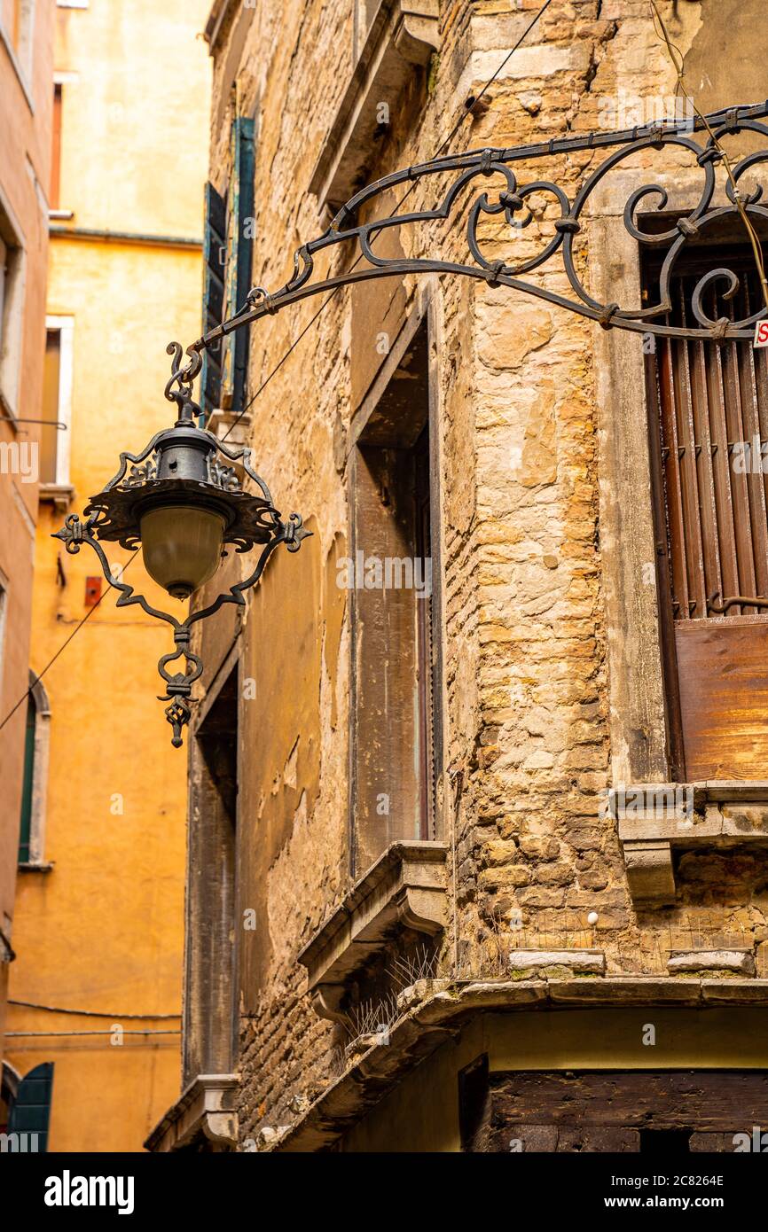 Vertical shot of a street lamp with an old brick building on the ...