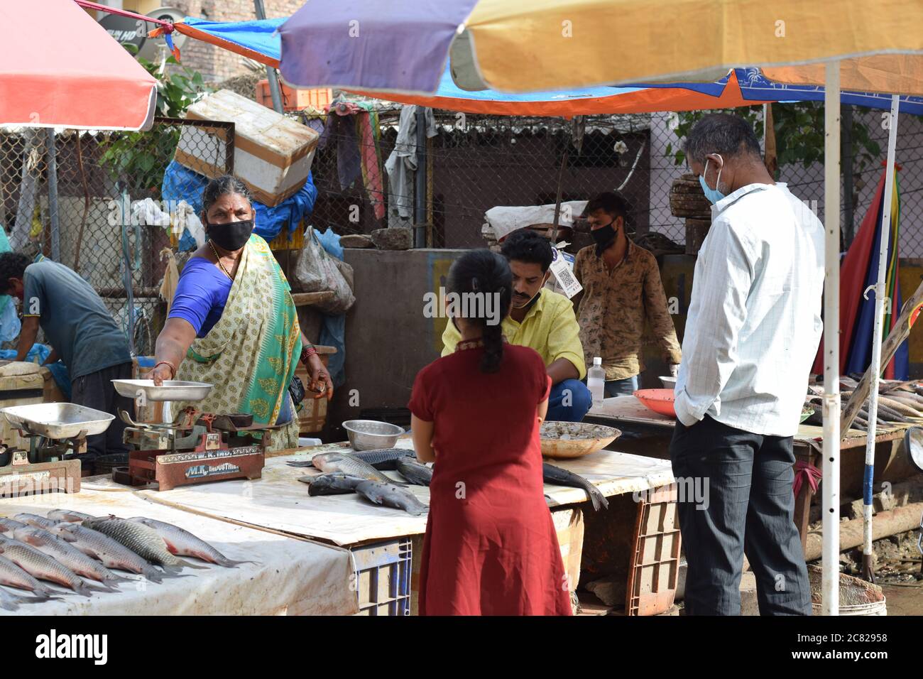 Hyderabad, Telangana, India. july202020 peoples wearing at fish market, customer buying fish