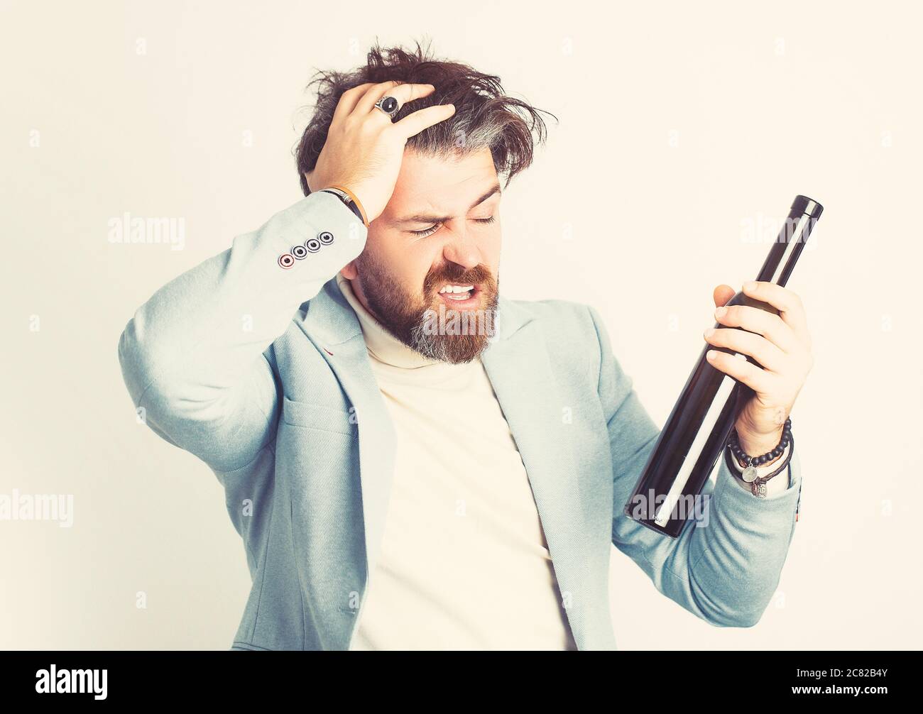 People, alcohol and drinks concept - senior man drinking red wine. Stock Photo