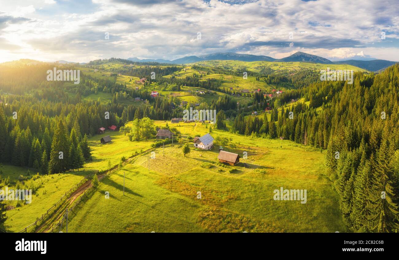 Aerial view of small village in Carpathian mountains at sunset Stock Photo