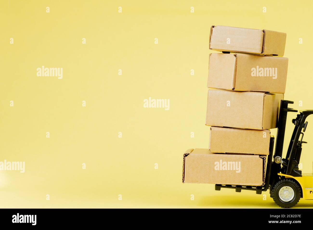 Mini forklift truck load cardboard boxes. Logistics and transportation ...