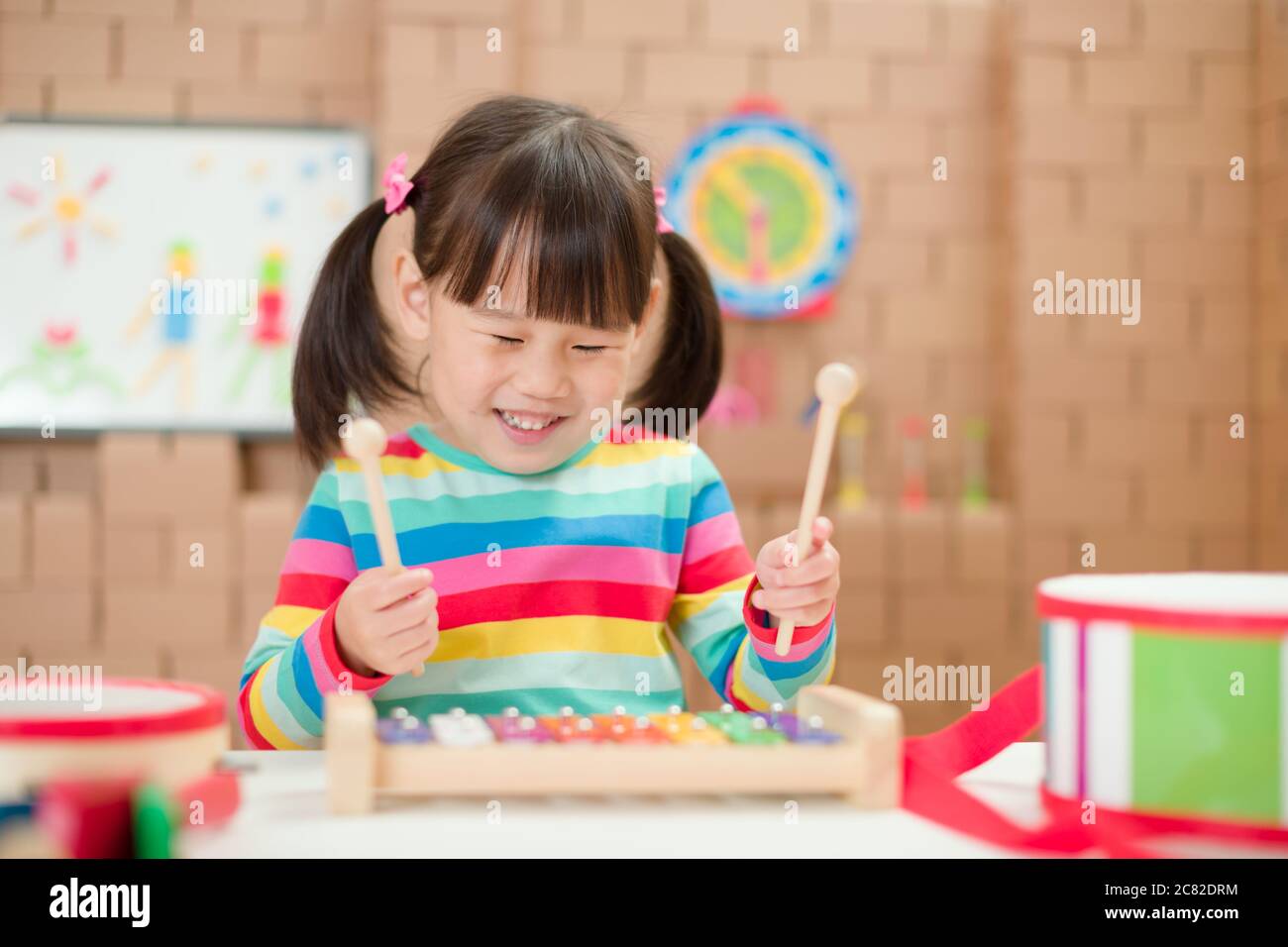 toddler girl play xylophone at home for homeschooling Stock Photo Alamy