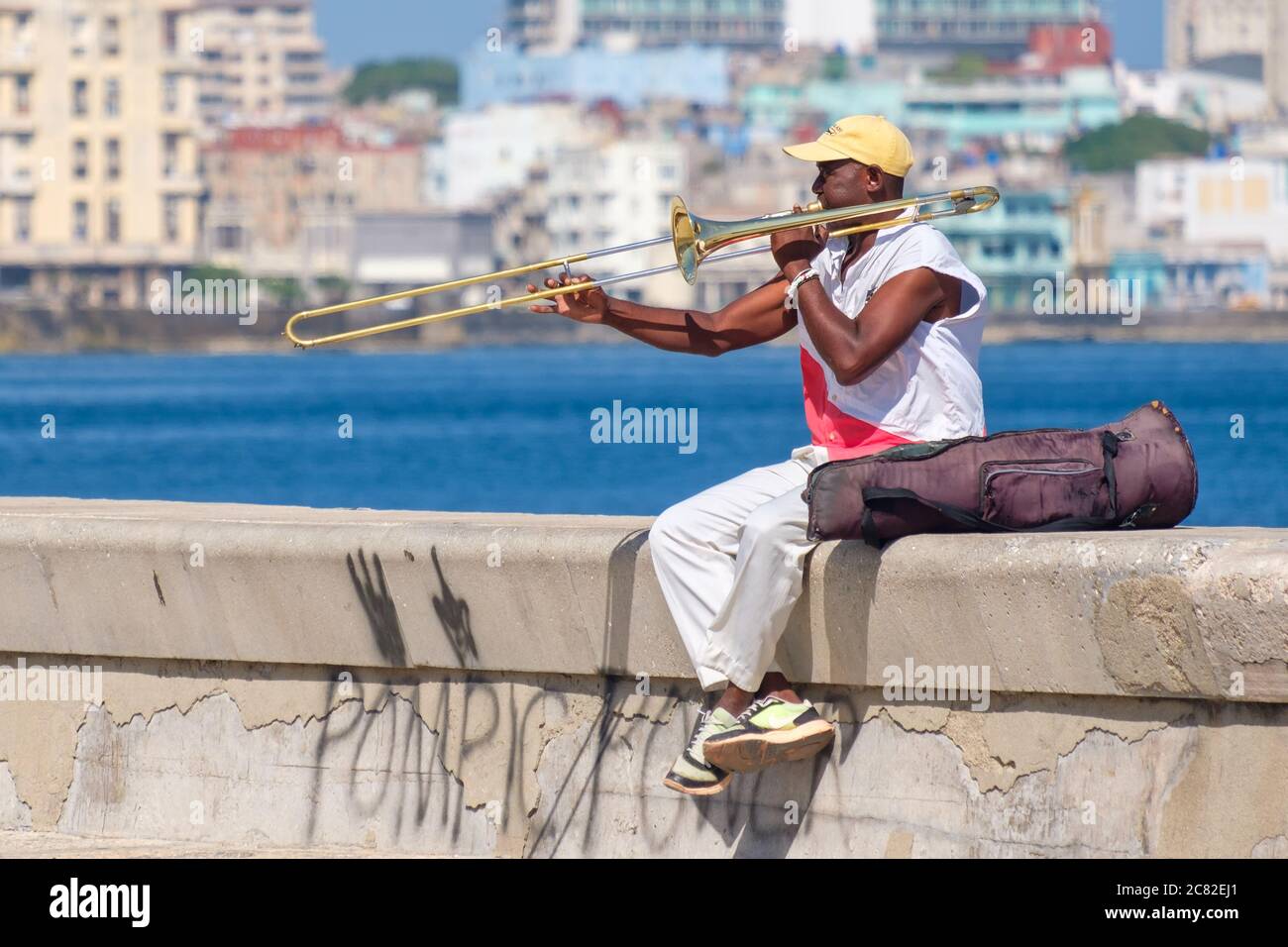 A street musician plays the trombone at the famous seaside Malecon wall in Havana Stock Photo