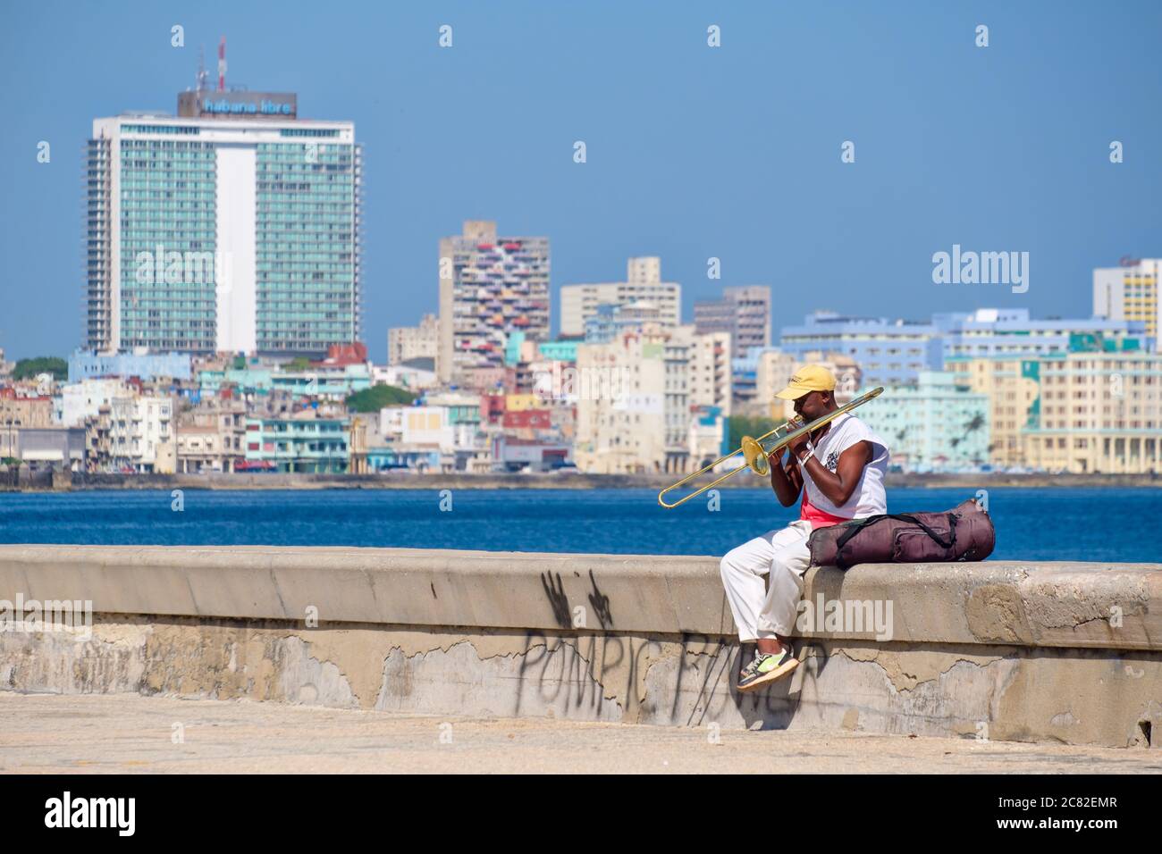 A street musician plays the trombone at the famous seaside Malecon wall in Havana Stock Photo