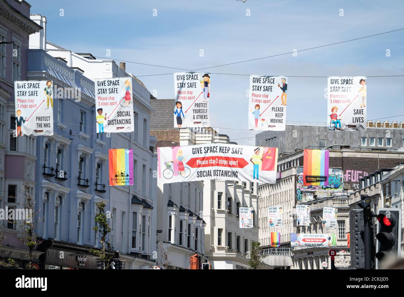 Coronavirus / covid-19 banners give space, stay safe, social distancing above a street in Brighton, UK, 2020. Stock Photo