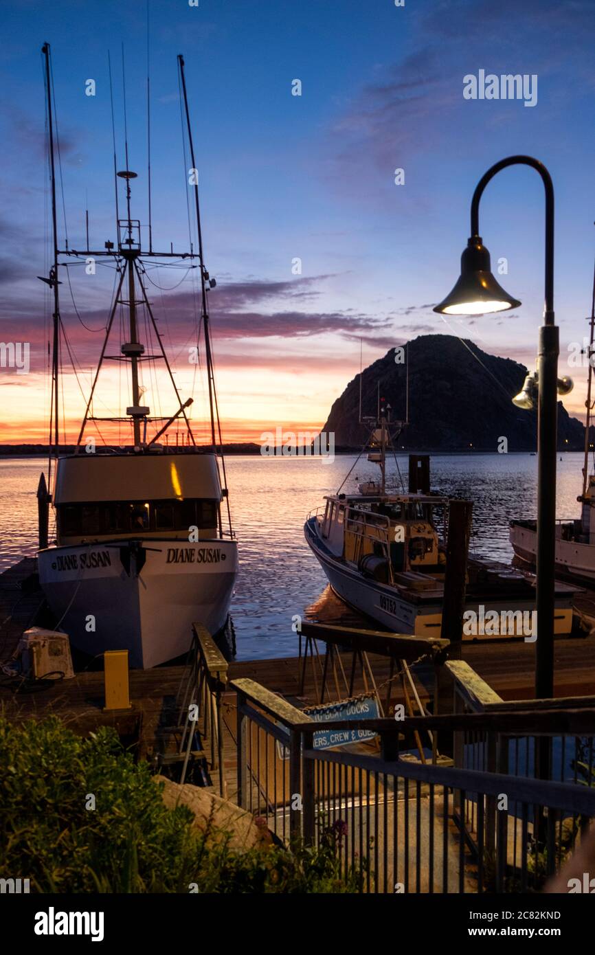 Dusk in Morro Bay at a fishing boat dock with light along the central coast of California Stock Photo