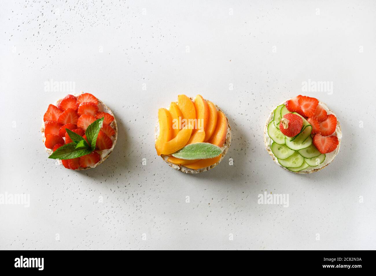 Puffed rice cakes with different toppings friuts and vegetables on