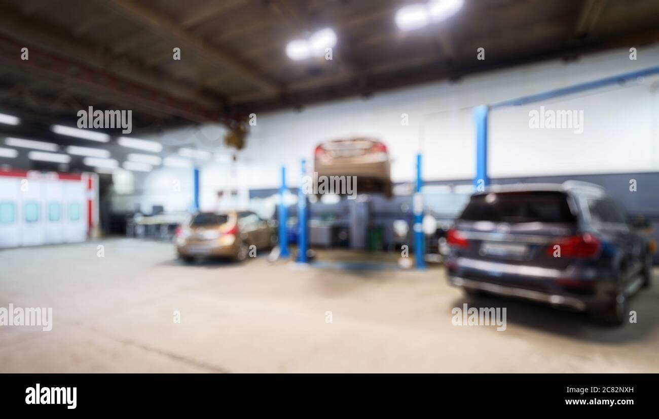 Auto repair interior in bokeh, blurred defocused background