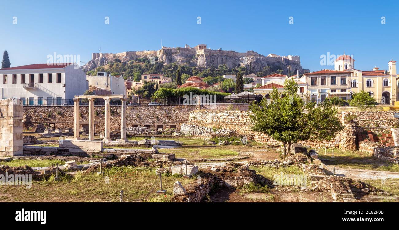 Panorama of Library of Hadrian overlooking Acropolis, Athens, Greece. It are famous tourist attractions of city. Urban landscape of Athens with classi Stock Photo