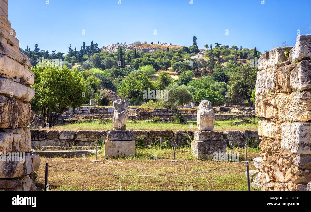 Ancient Agora in summer, Athens, Greece. It is famous tourist attraction of Athens. Panorama of Agora with classical Greek ruins of historical Athens. Stock Photo