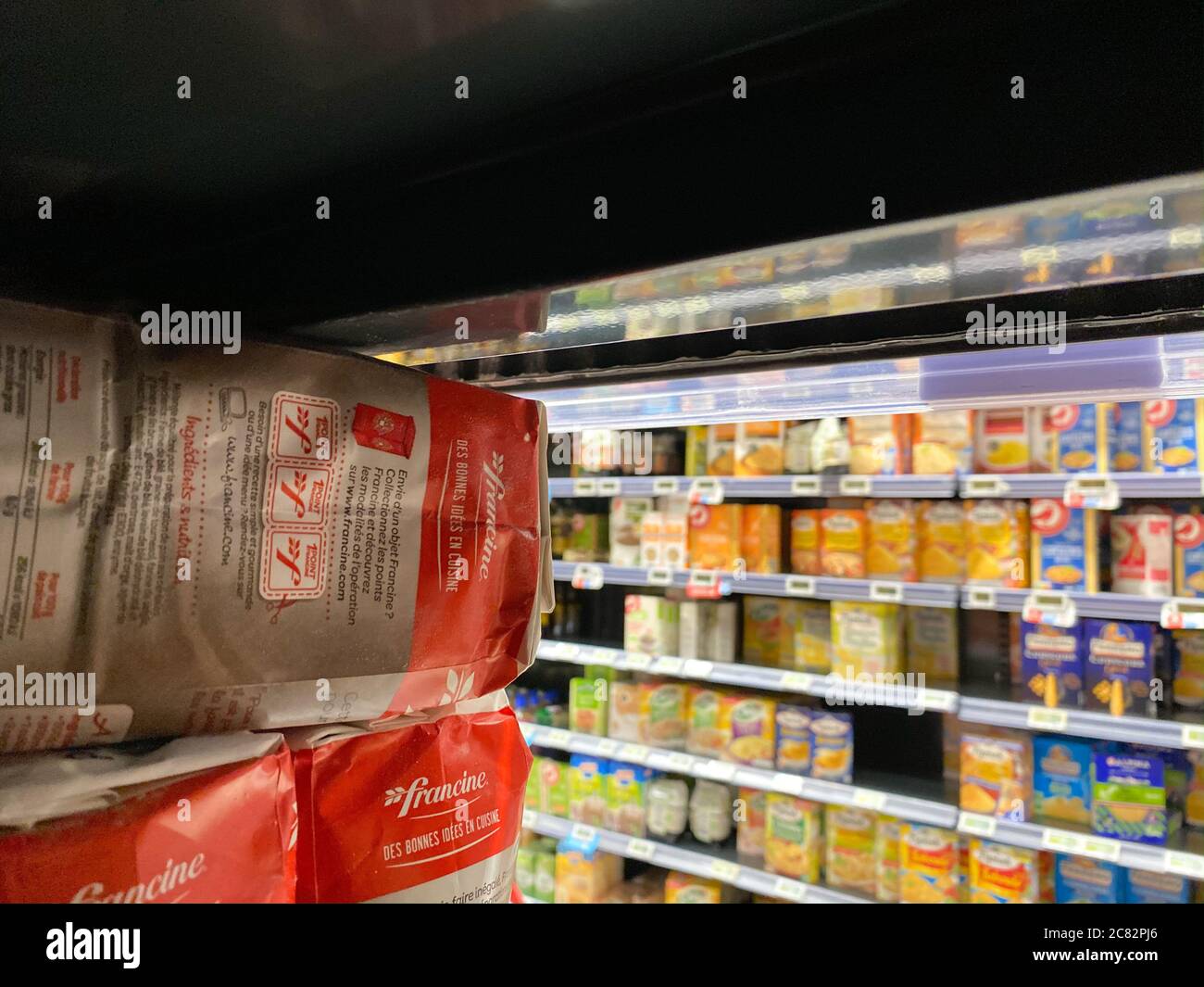 Paris, France - Mar 13, 2020: View from inside the empty shelves of food products in French supermarket during Coronavirus pandemic lockdown - Francine flour shopping Stock Photo