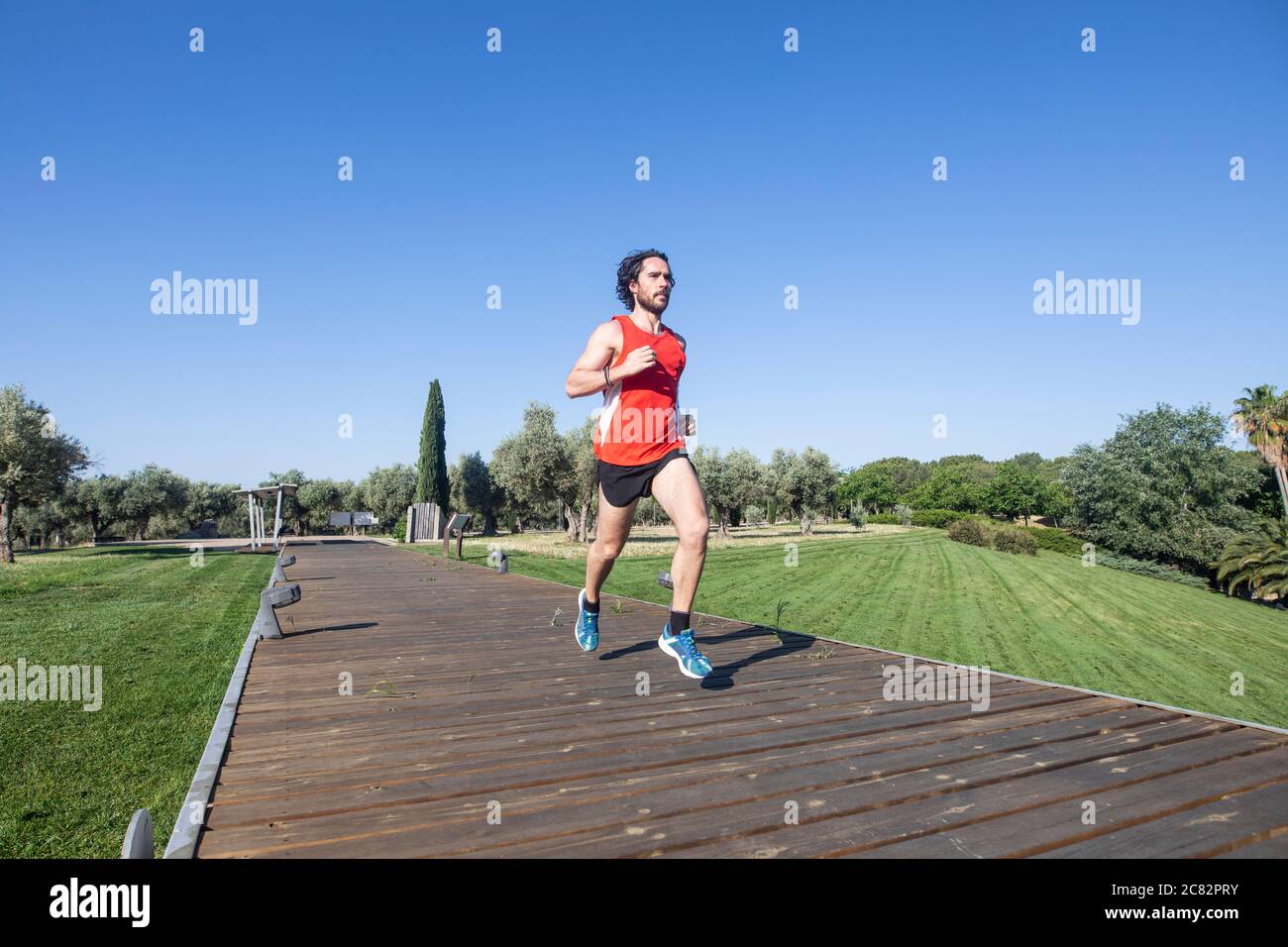 young man running in the city park Stock Photo