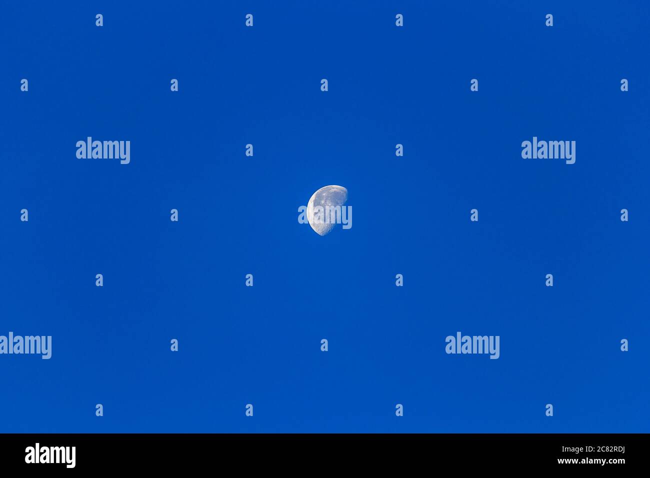 Clear blue sky with the moon background Stock Photo - Alamy
