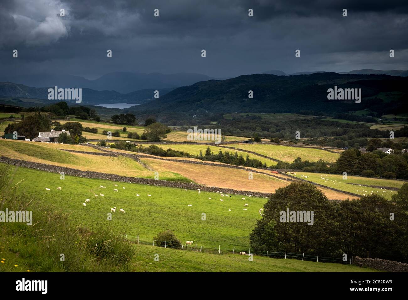 Dark clouds and heavy weather over Coniston Water and the Furness Fells from Park Gate near Grizebeck. Stock Photo