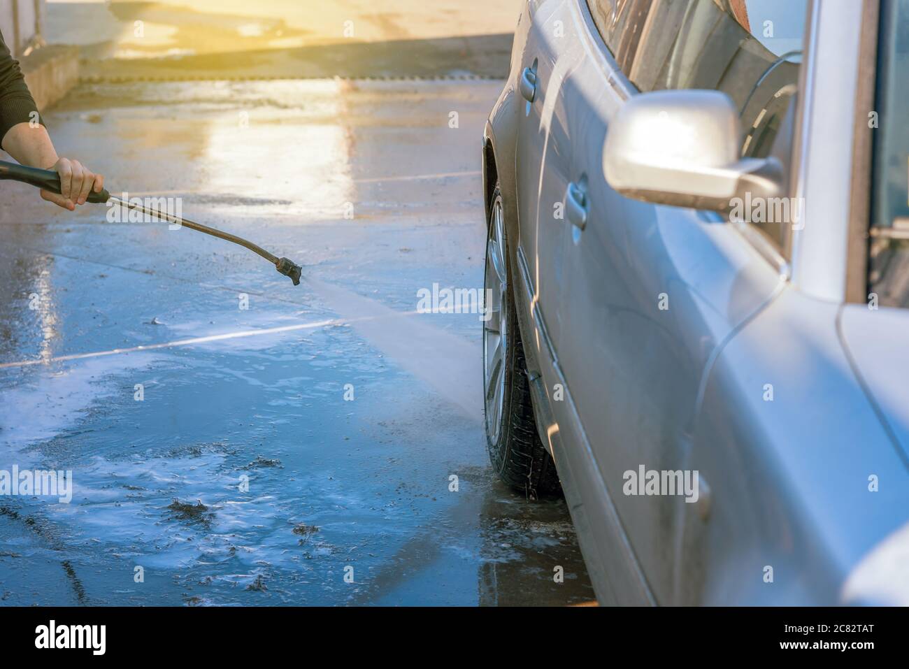 Car washing with flowing water. Outdoor Self Service Cleaning Car Using High Pressure Water Stock Photo