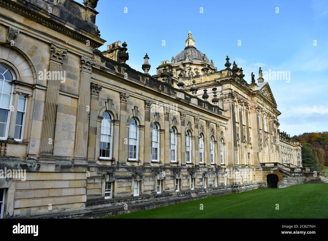 The South Front of Castle Howard. An historic stately home in North Yorkshire, England, on a bright sunny day. Green grass and blue sky. Stock Photo