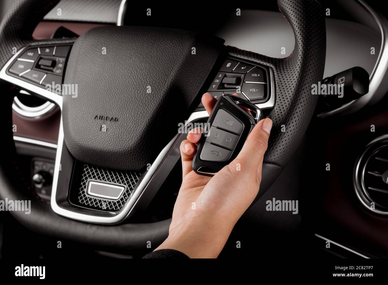 Woman's hand holding a remote key of a new SUV car Stock Photo - Alamy