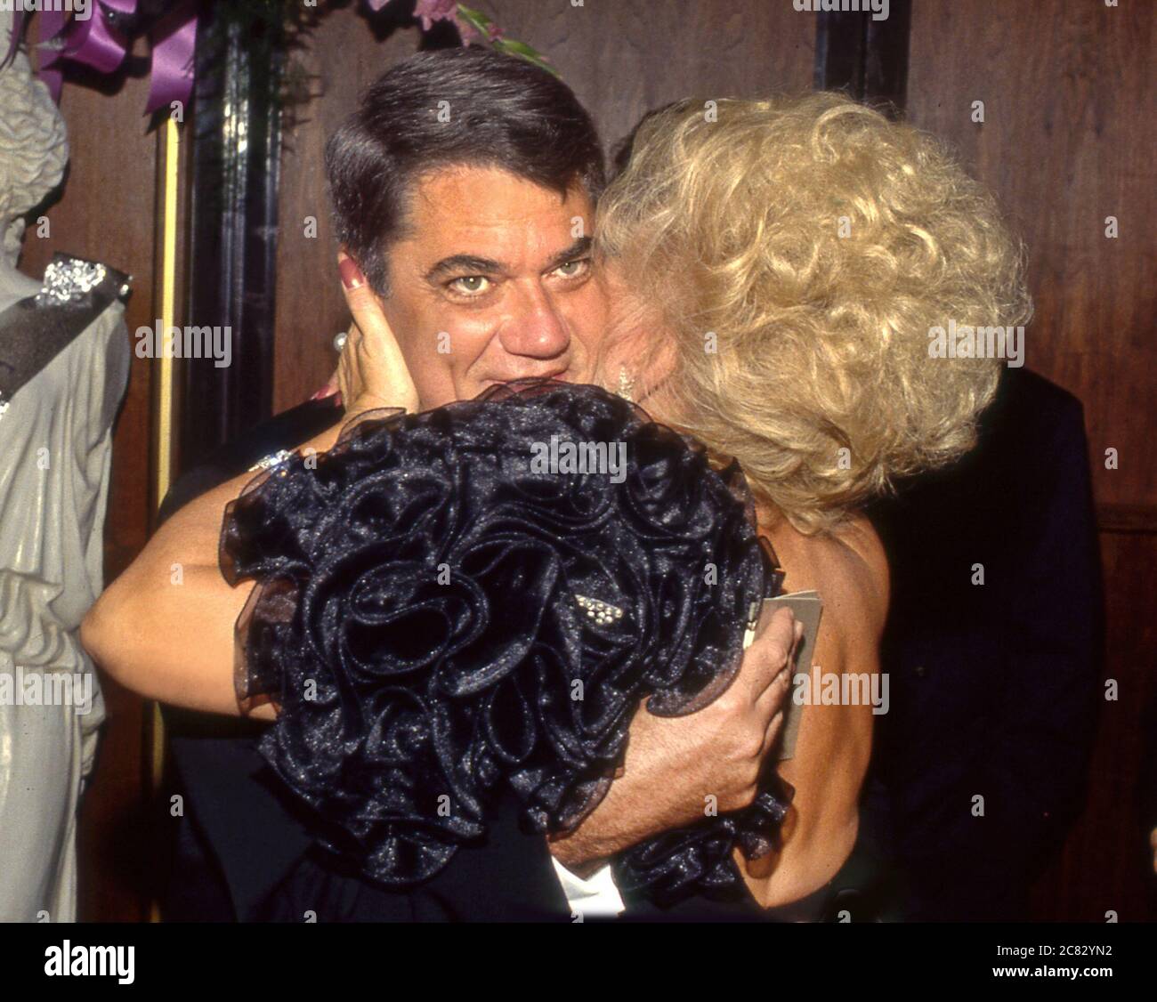 Film critic Rex Reed gets ahug from Ruta Lee at at Thalian's Ball in Beverly HIlls, CA Stock Photo