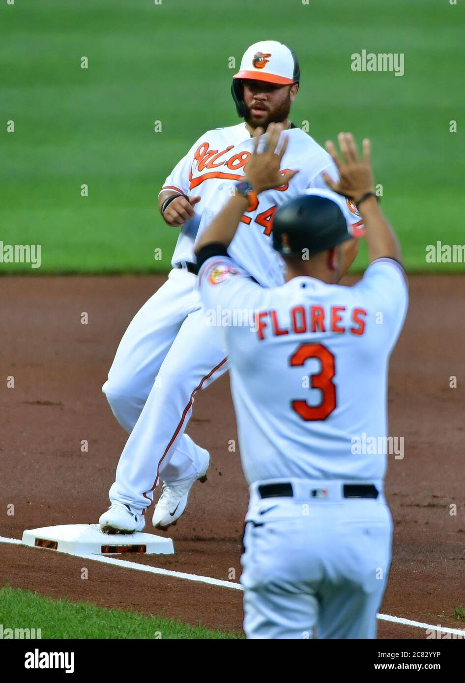 Baltimore, United States. 20th July, 2020. Baltimore Orioles third base  coach Jose Flores (3) signals to DJ Stewart (24) as he advances against the  Washington Nationals during the first inning of a