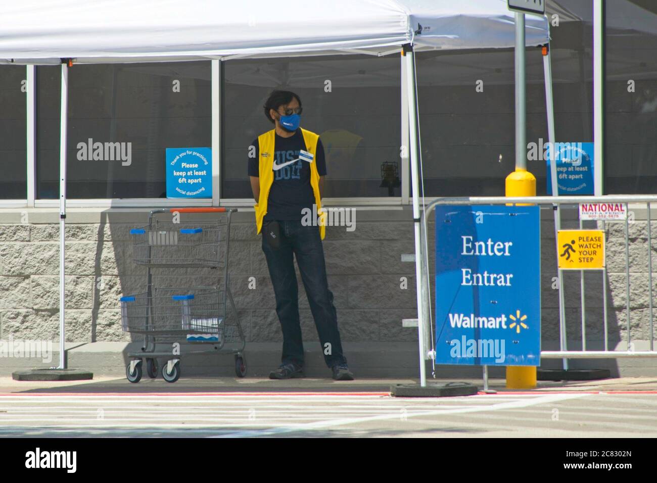 Plano, USA. 20th July, 2020. A Walmart Health Ambassador stands by the