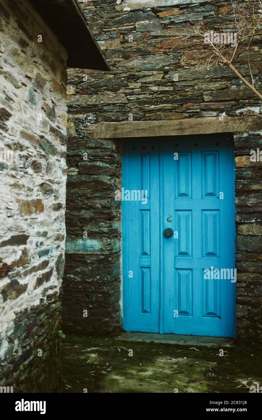 Facade of the old buildings with a blue wooden door Stock Photo - Alamy