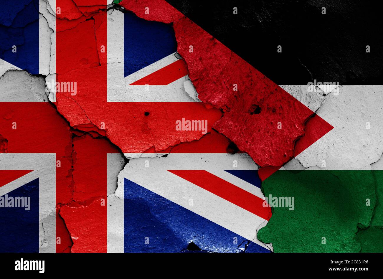 flags of UK and Palestine painted on cracked wall Stock Photo