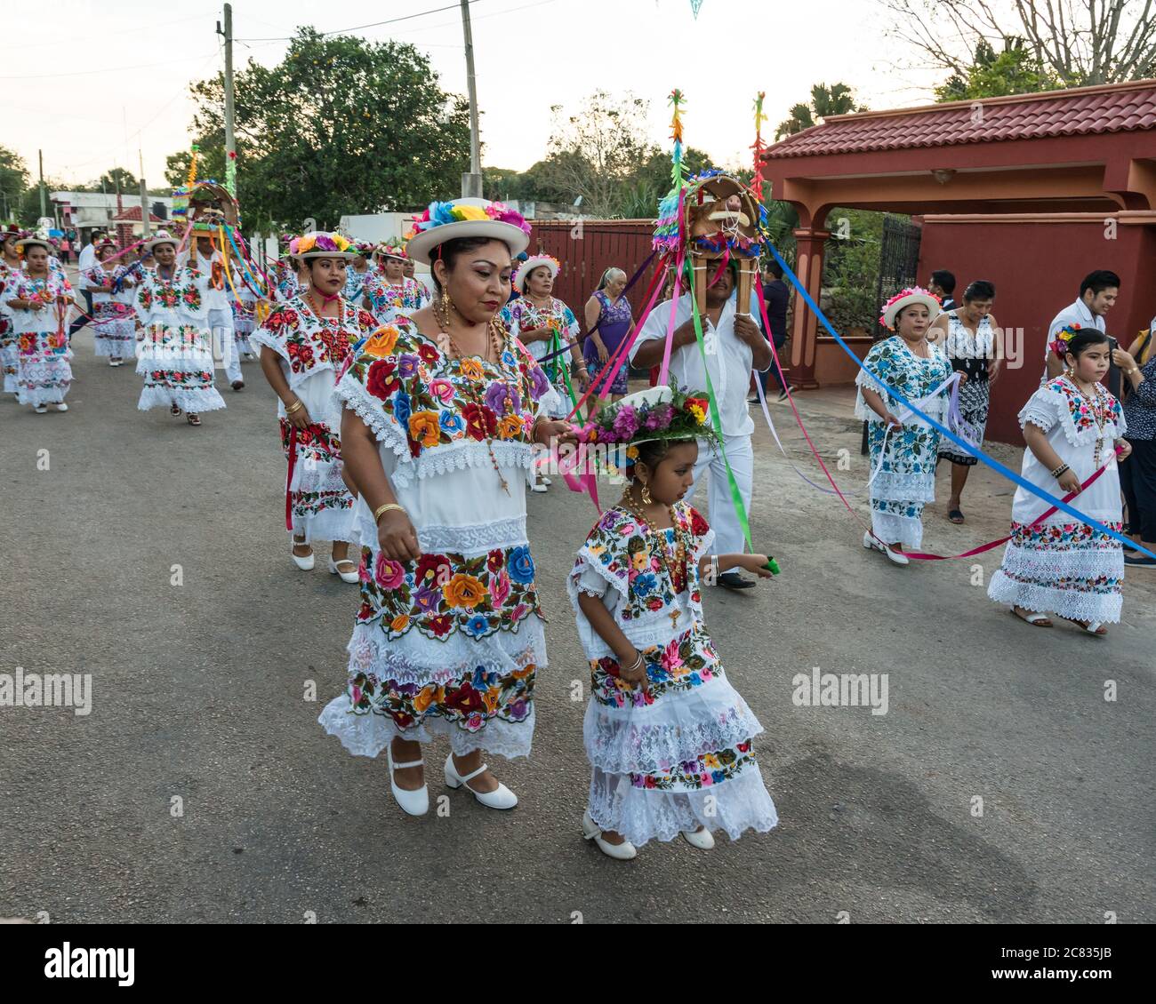 Women in tradtional festive embroidered huipils and flowered hats dance the Dance of the Pig's Head and of the Turkey, or Baile de la cabeza del cochi Stock Photo