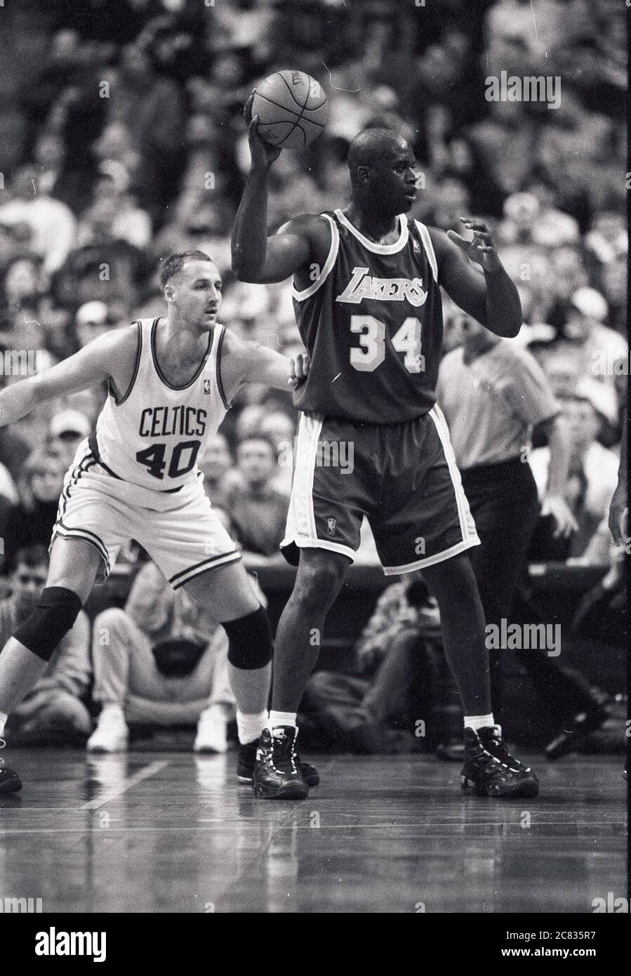 LA Lakers Shaquille O’Neal #34 (right) looks to pass the ball in game action against the Boston Celtics , at left Celtics Dino Radja during 1996-97 season at the Fleet Center in Boston Ma USA photoby Bill Belknap Stock Photo