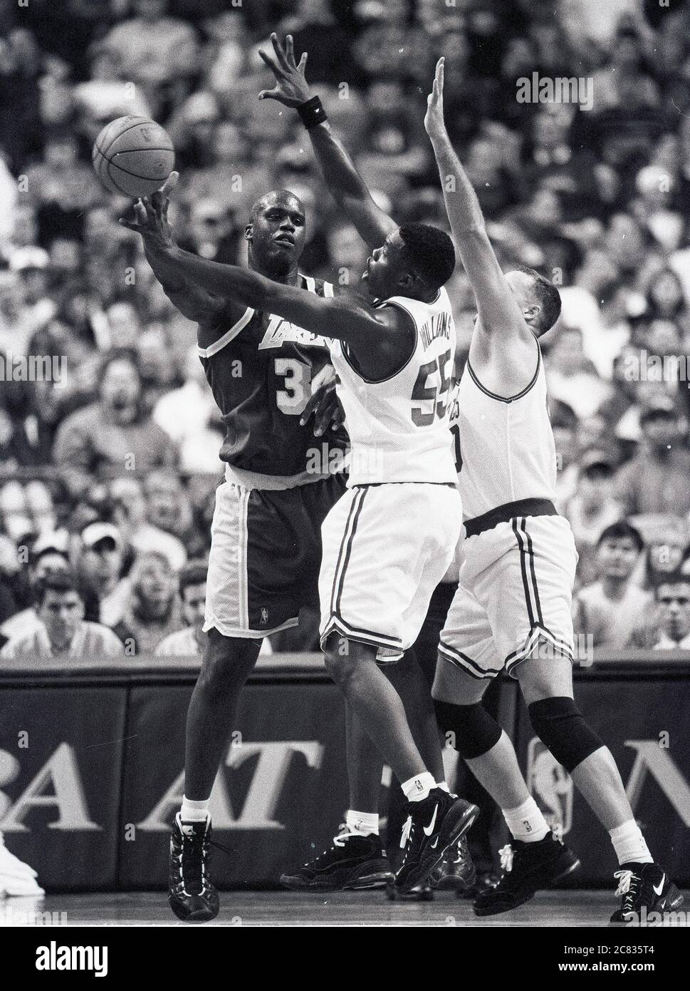 LA Lakers Shaquille O’Neal  (left) passes off the ball against defending Boston Celtics Eric Williams #55 (center) and Dino Radja #40 (right) in game action  at the Fleet Center in Boston Ma USA photo by bill belknap Stock Photo