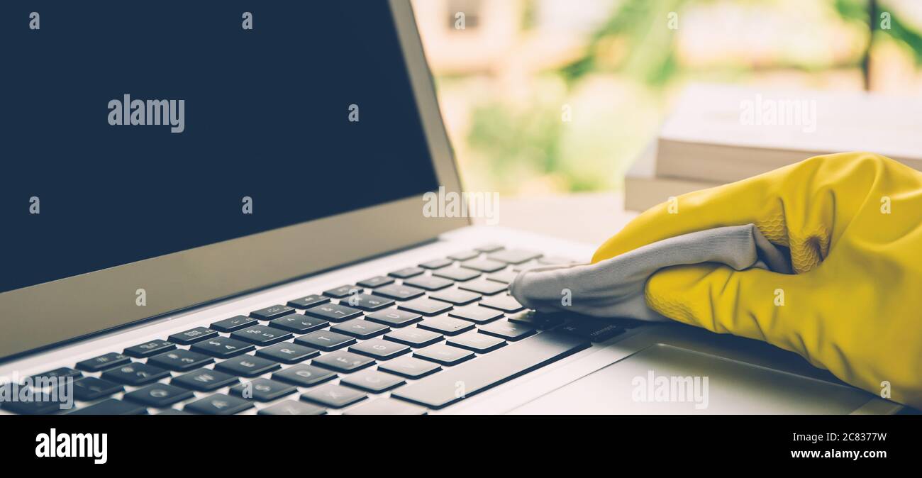 Hand of man cleaning keyboard computer with antibacterial for protect