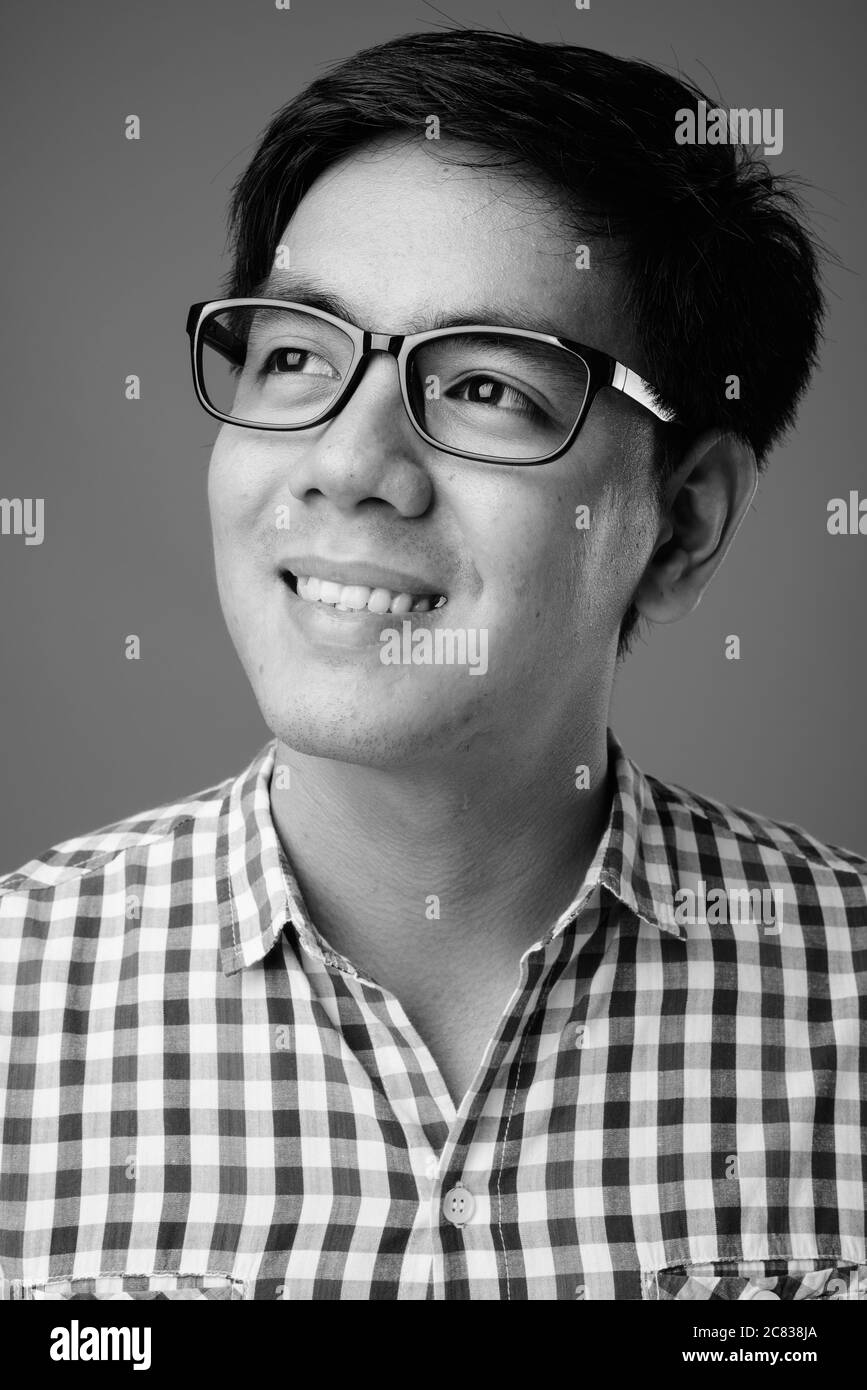 Portrait of young handsome Filipino hipster man with eyeglasses Stock Photo