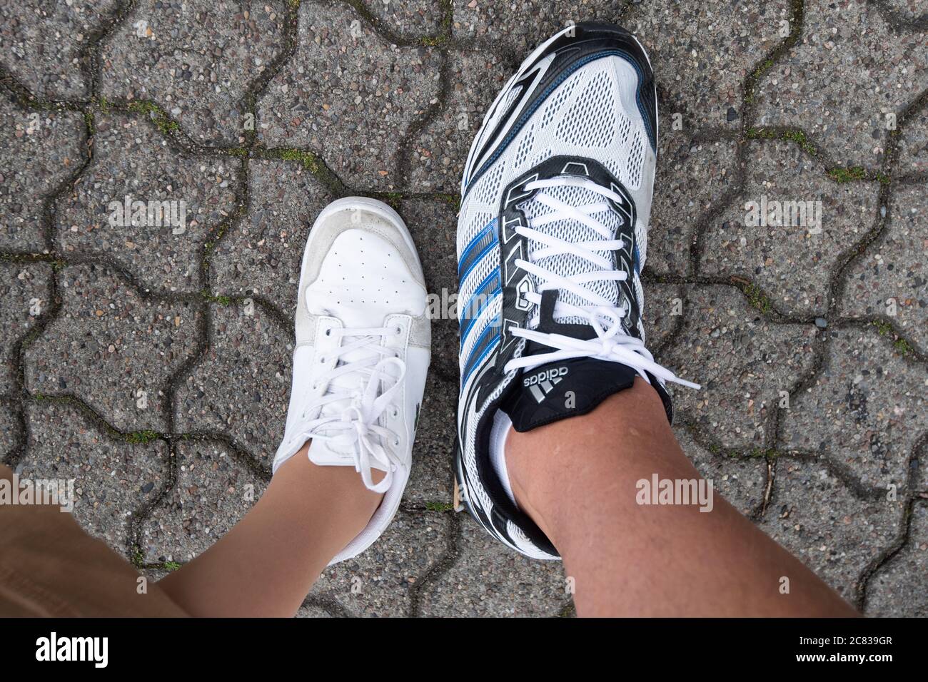 Hanover, Germany. 20th July, 2020. A woman with shoe size 38 stands next to  Jannik Könecke with shoe size 55. Jannik Könecke is 2.24 metres tall and  one of the tallest Germans.