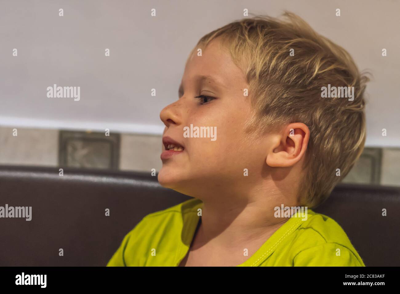 Close up portrait cute boy change his mood from smiling till serious, surprised, intriguing, cunning, funny, mischievous, sad, daydreaming. Happy Stock Photo